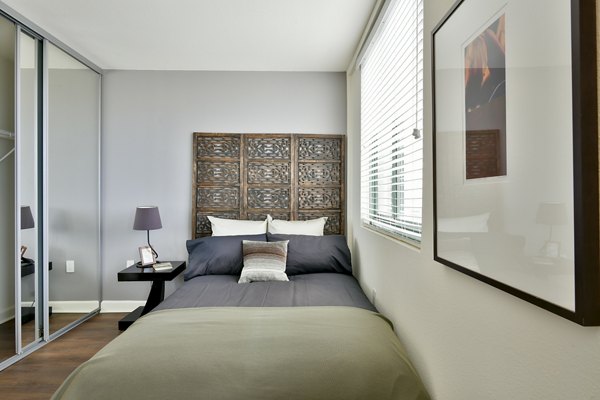 Cozy studio bedroom with modern furnishings at The Fillmore Center Apartments in a  community