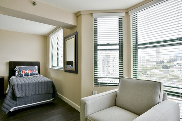 Studio bedroom with modern furnishings at The Fillmore Center Apartments, luxury Greystar property in vibrant city setting