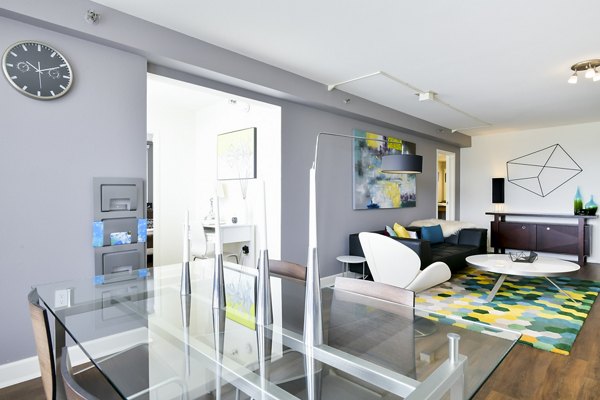 Dining room with modern decor and large windows at The Fillmore Center Apartments