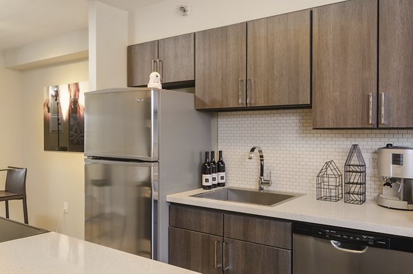 Modern kitchen with stainless steel appliances at The Fillmore Center apartments