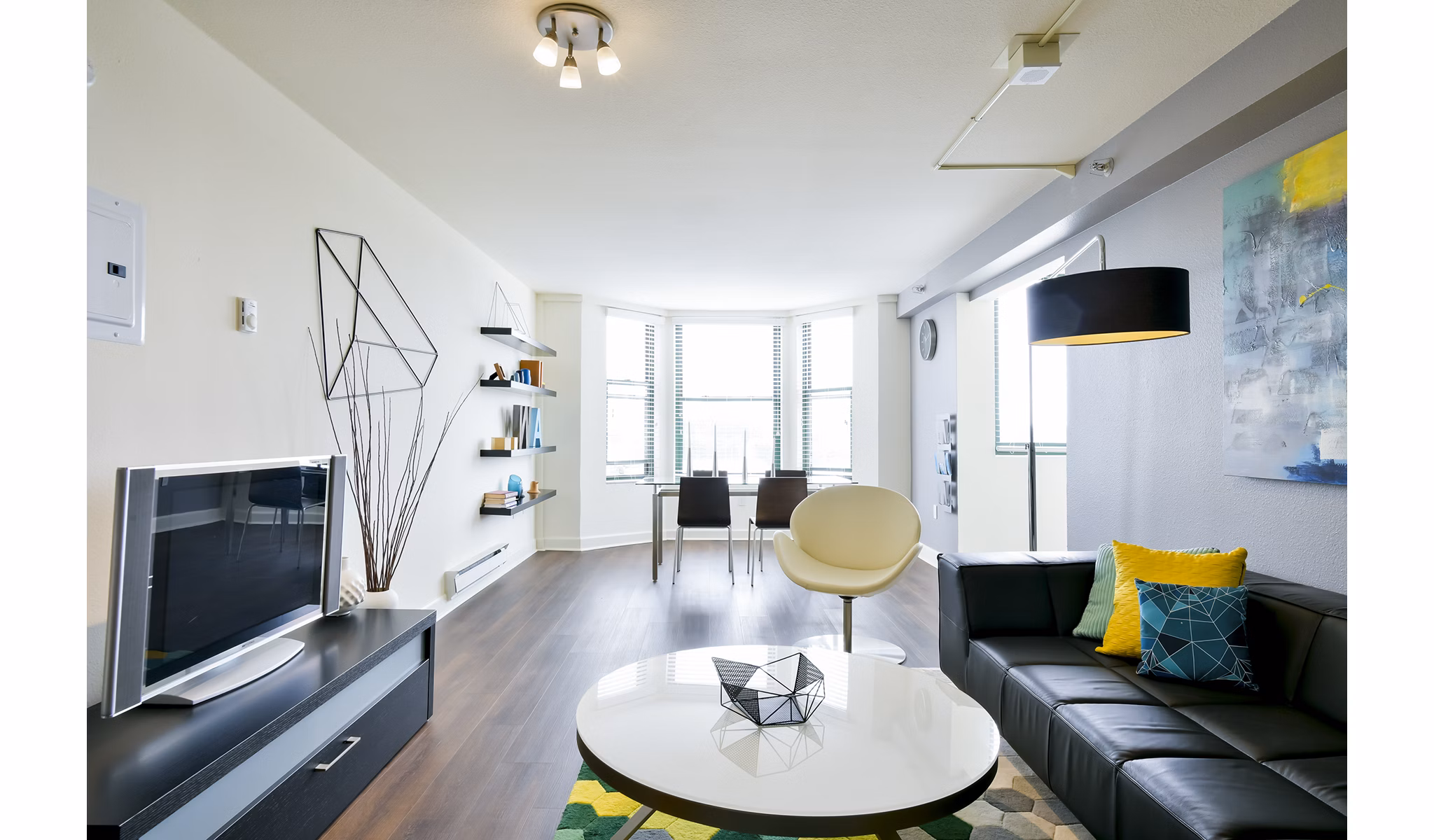 Living room with modern decor and large windows at The Fillmore Center Apartments in San Francisco