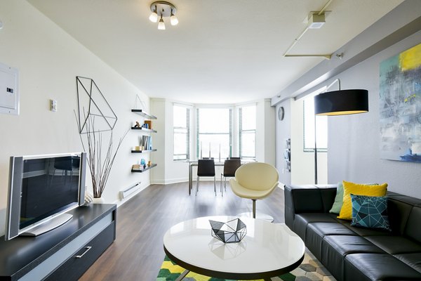 Living room with modern decor and large windows at The Fillmore Center Apartments in San Francisco