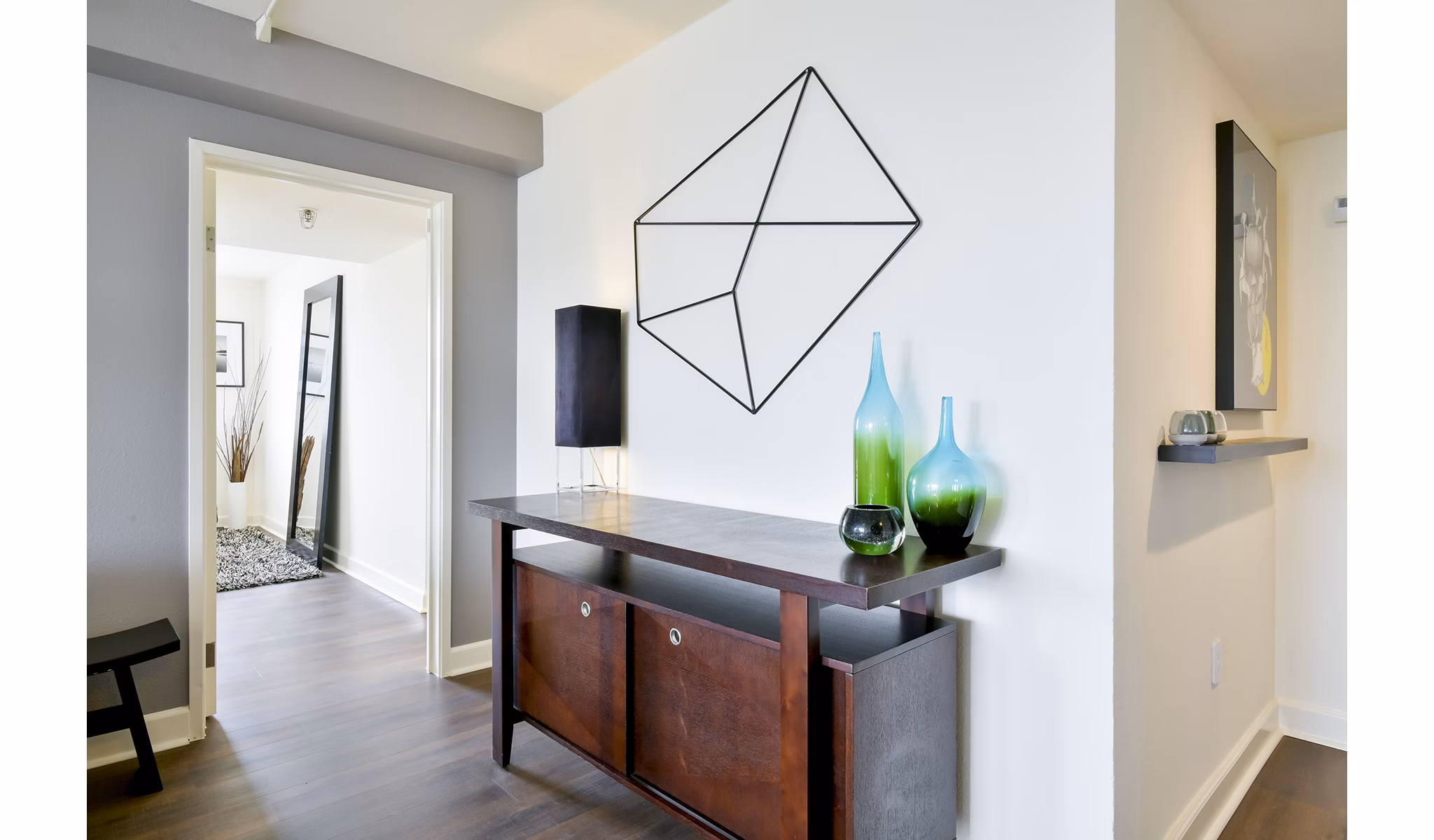 Modern living room with sleek furnishings and artful decor at The Fillmore Center Apartments