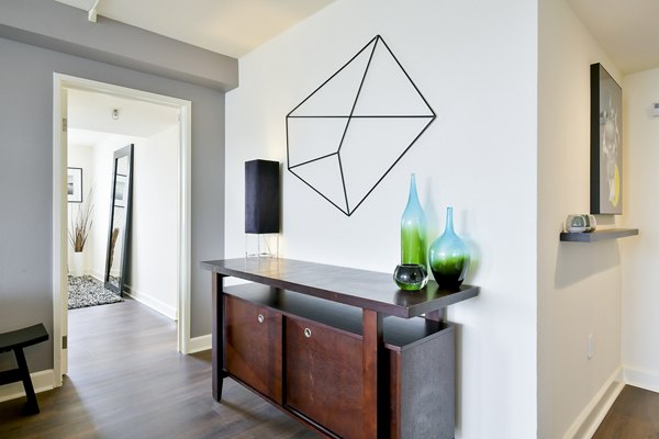 Modern living room with sleek furnishings and artful decor at The Fillmore Center Apartments