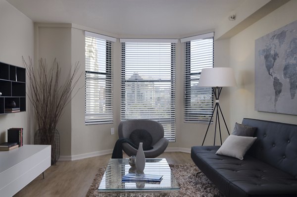 Living room featuring contemporary design and large windows in The Fillmore Center luxury apartments