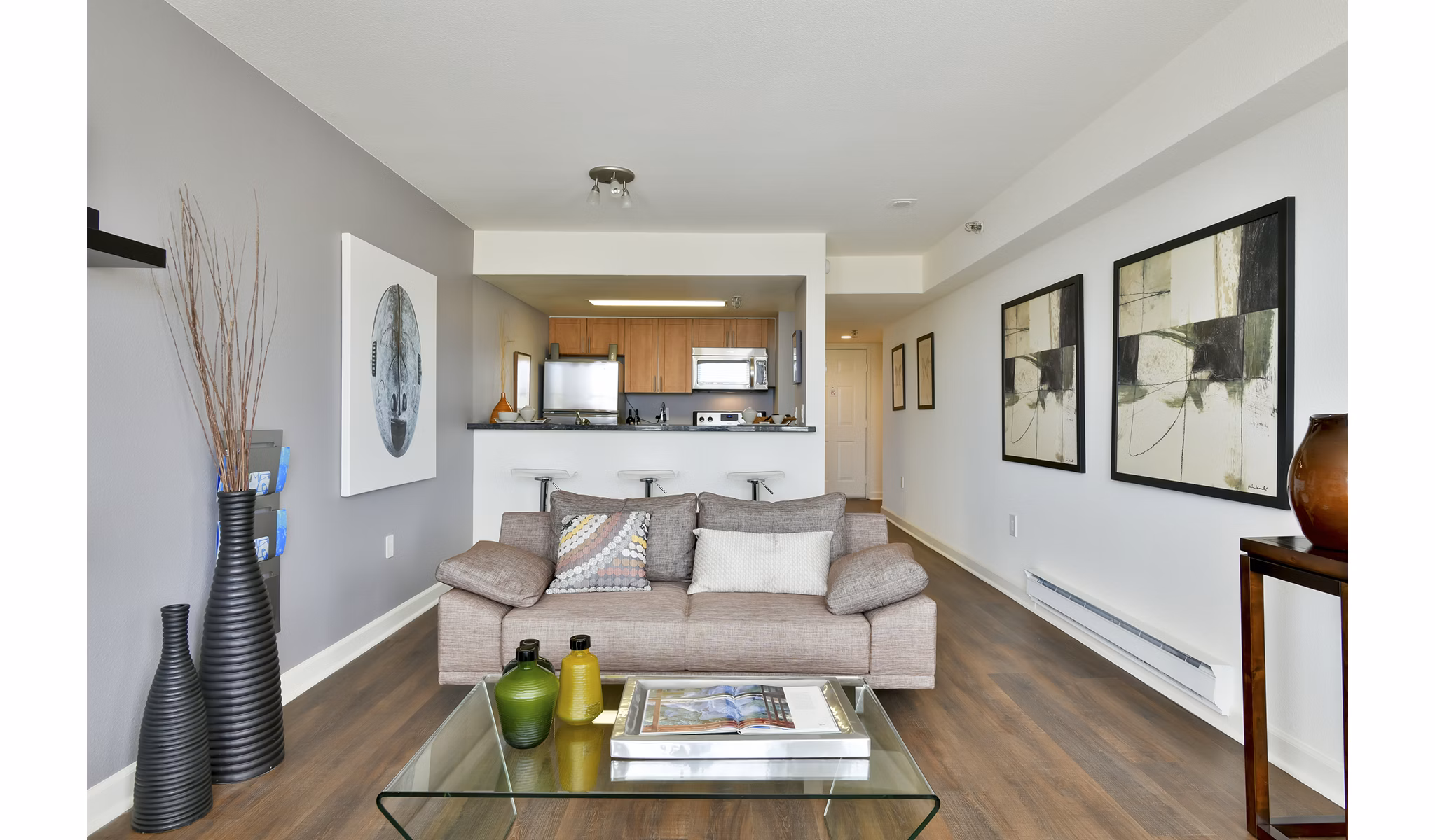 Spacious living room with modern decor and large windows in The Fillmore Center Apartments