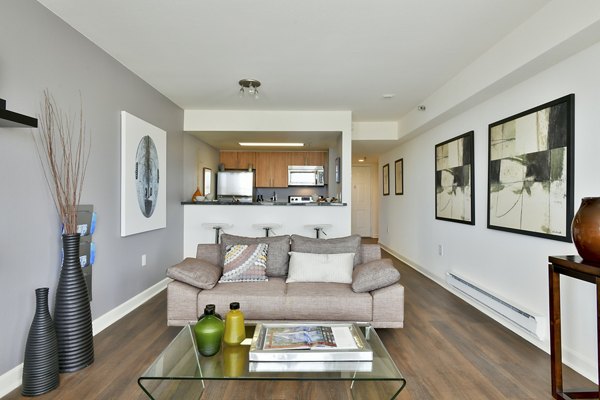 Spacious living room with modern decor and large windows in The Fillmore Center Apartments