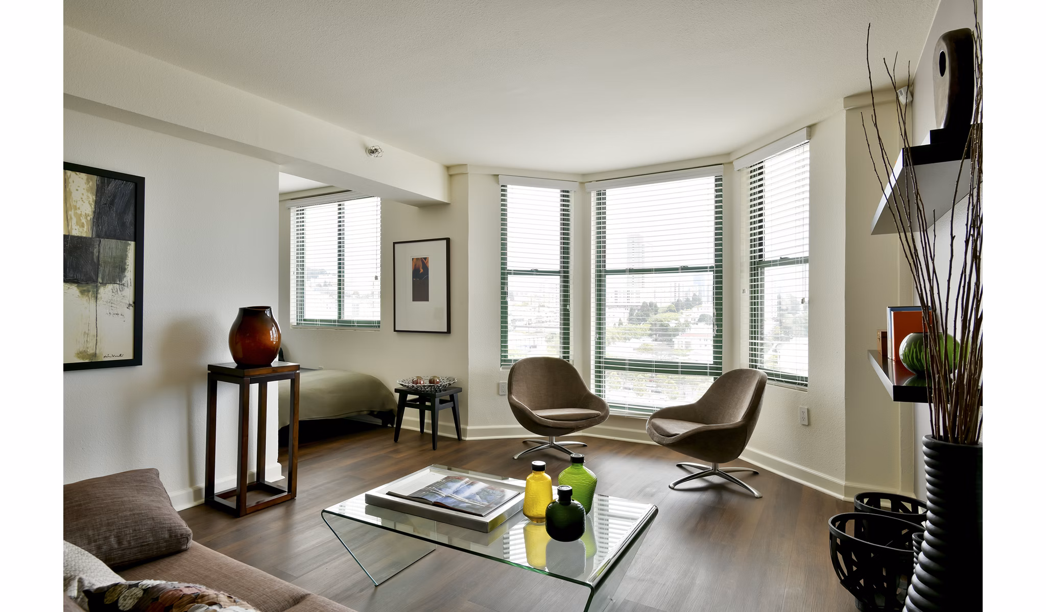 Spacious living room with modern furniture and large windows in The Fillmore Center Apartments
