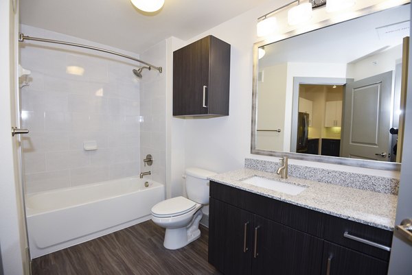 Modern bathroom with sleek fixtures and ample storage at Encore Montrose Apartments