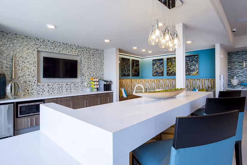 Clubhouse featuring modern design and ample seating at Encore Montrose Apartments