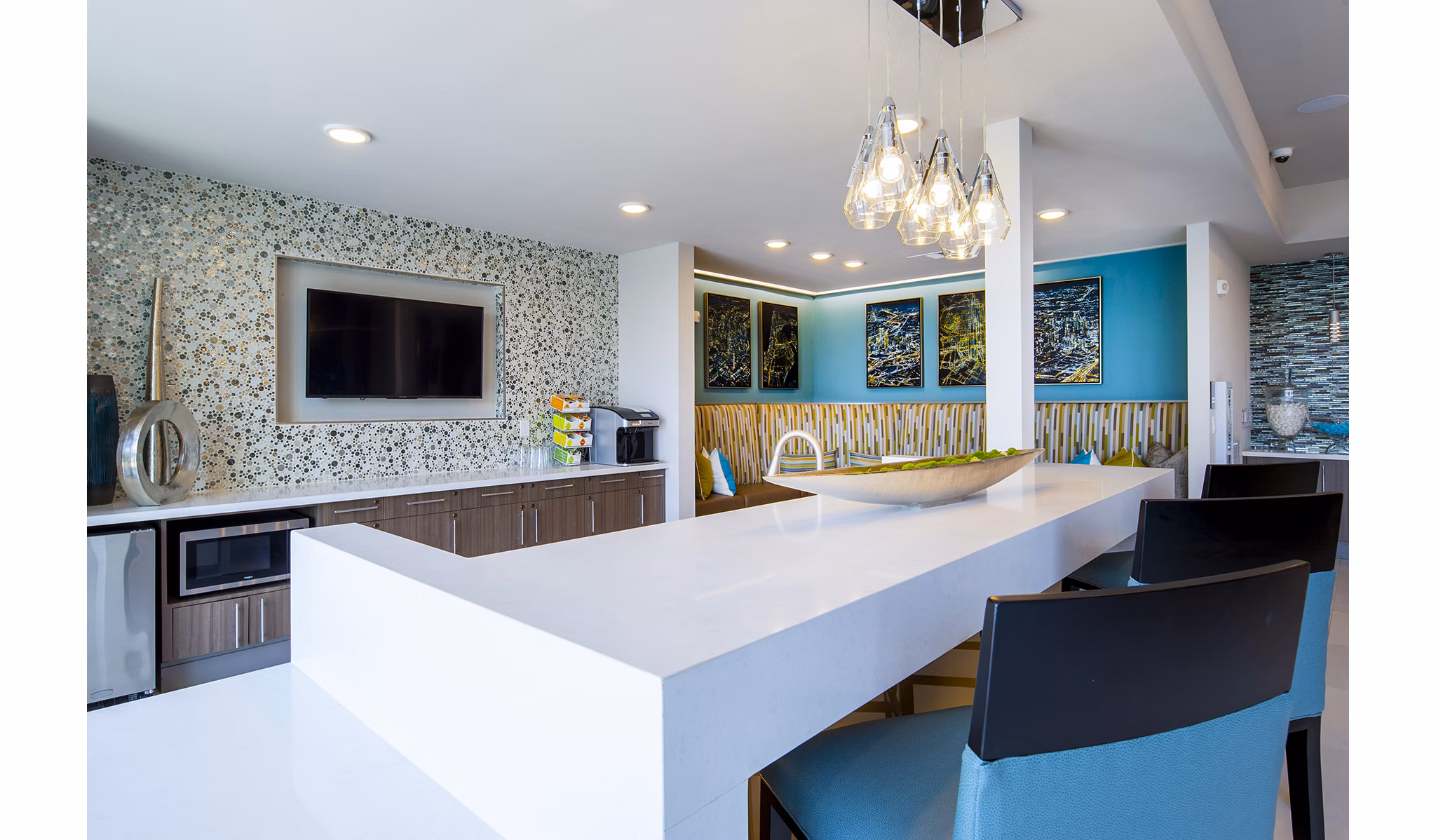 Clubhouse featuring modern design and ample seating at Encore Montrose Apartments