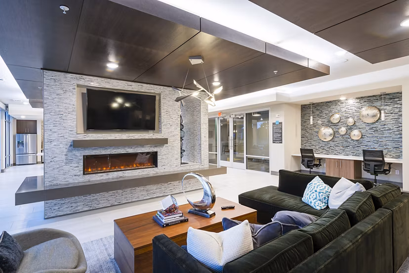 Clubhouse featuring modern furnishings and vibrant decor at Encore Montrose Apartments