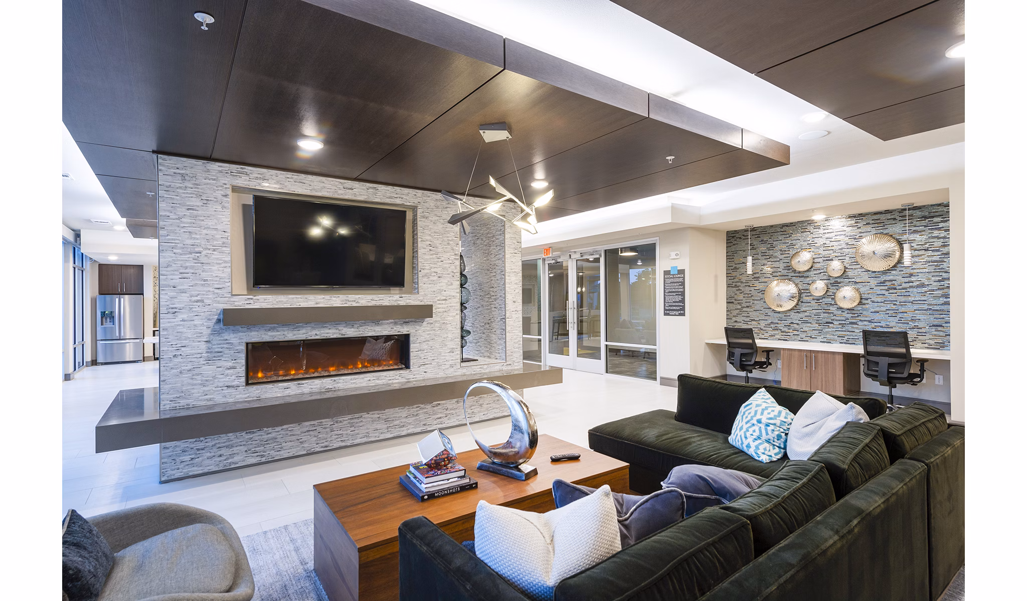 Clubhouse featuring modern furnishings and vibrant decor at Encore Montrose Apartments