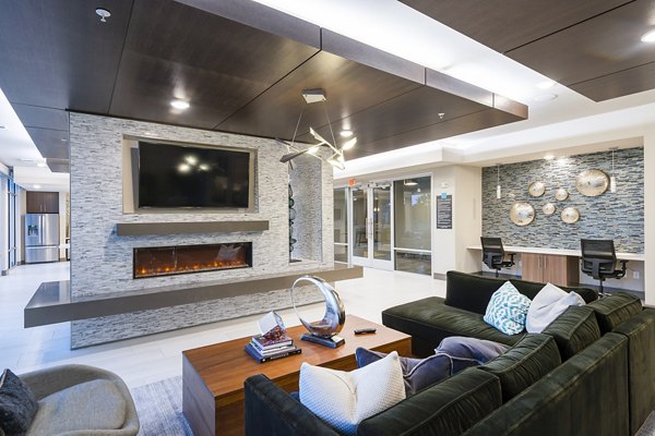 Clubhouse featuring modern furnishings and vibrant decor at Encore Montrose Apartments