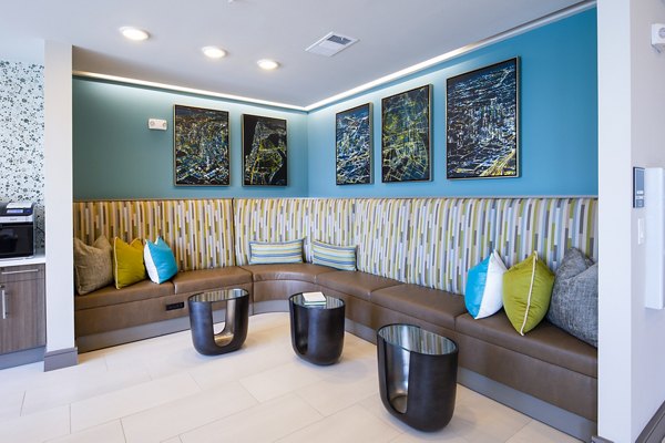 Clubhouse featuring modern decor and seating at Encore Montrose Apartments, an exclusive community offering luxury lifestyle amenities for residents