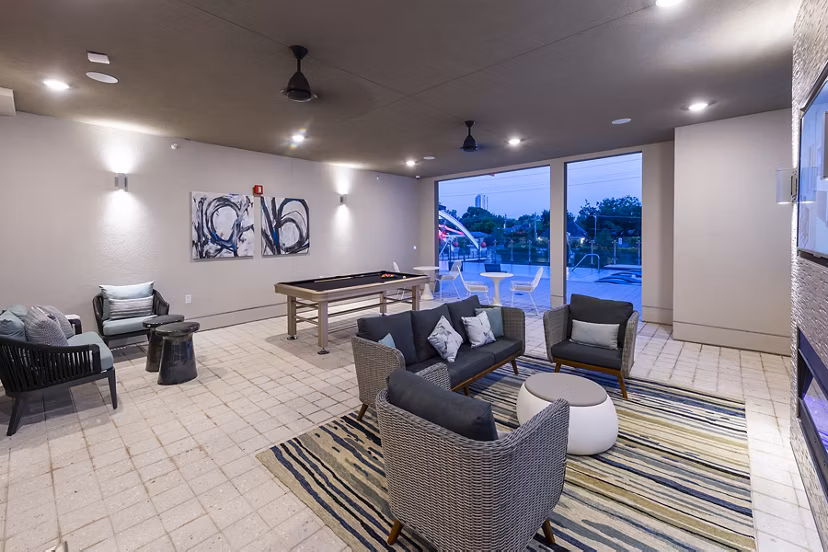 Game room featuring billiards and arcade games at Encore Montrose Apartments