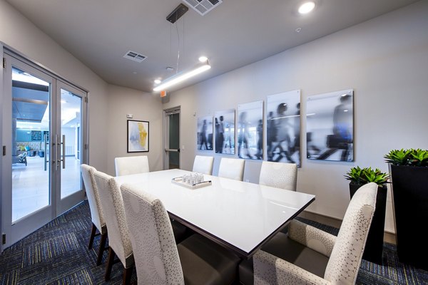 Clubhouse featuring modern seating and game area at Encore Montrose Apartments