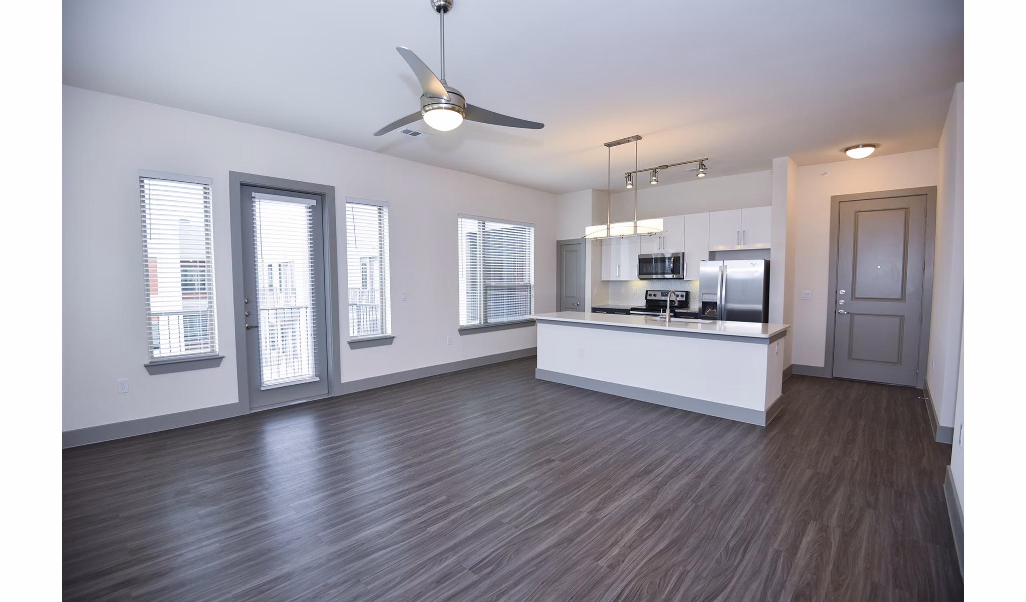 Inviting living room with modern decor and large windows at Encore Montrose Apartments, a luxury community in the heart of the city