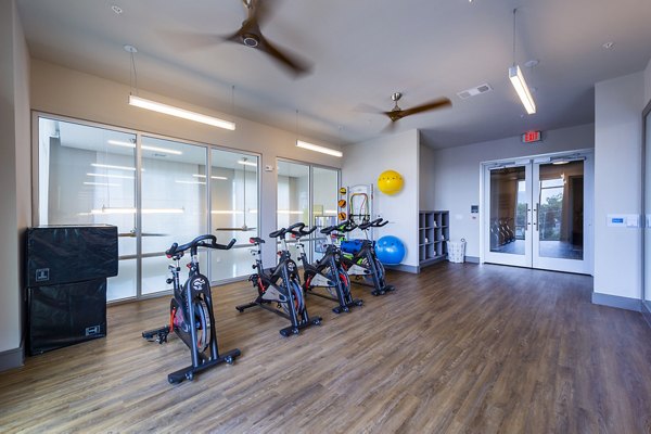 Yoga and spin studio with natural light at Encore Montrose Apartments A serene space promoting fitness and well-being