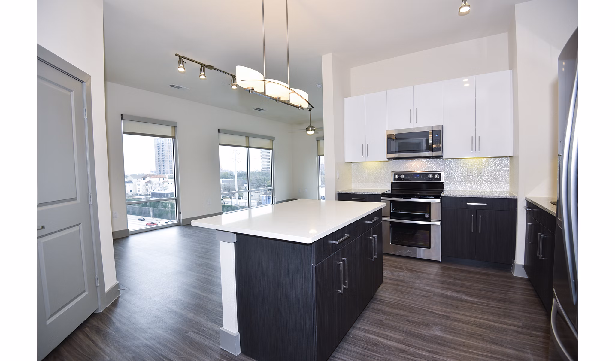 Modern kitchen with stainless steel appliances at Encore Montrose Apartments