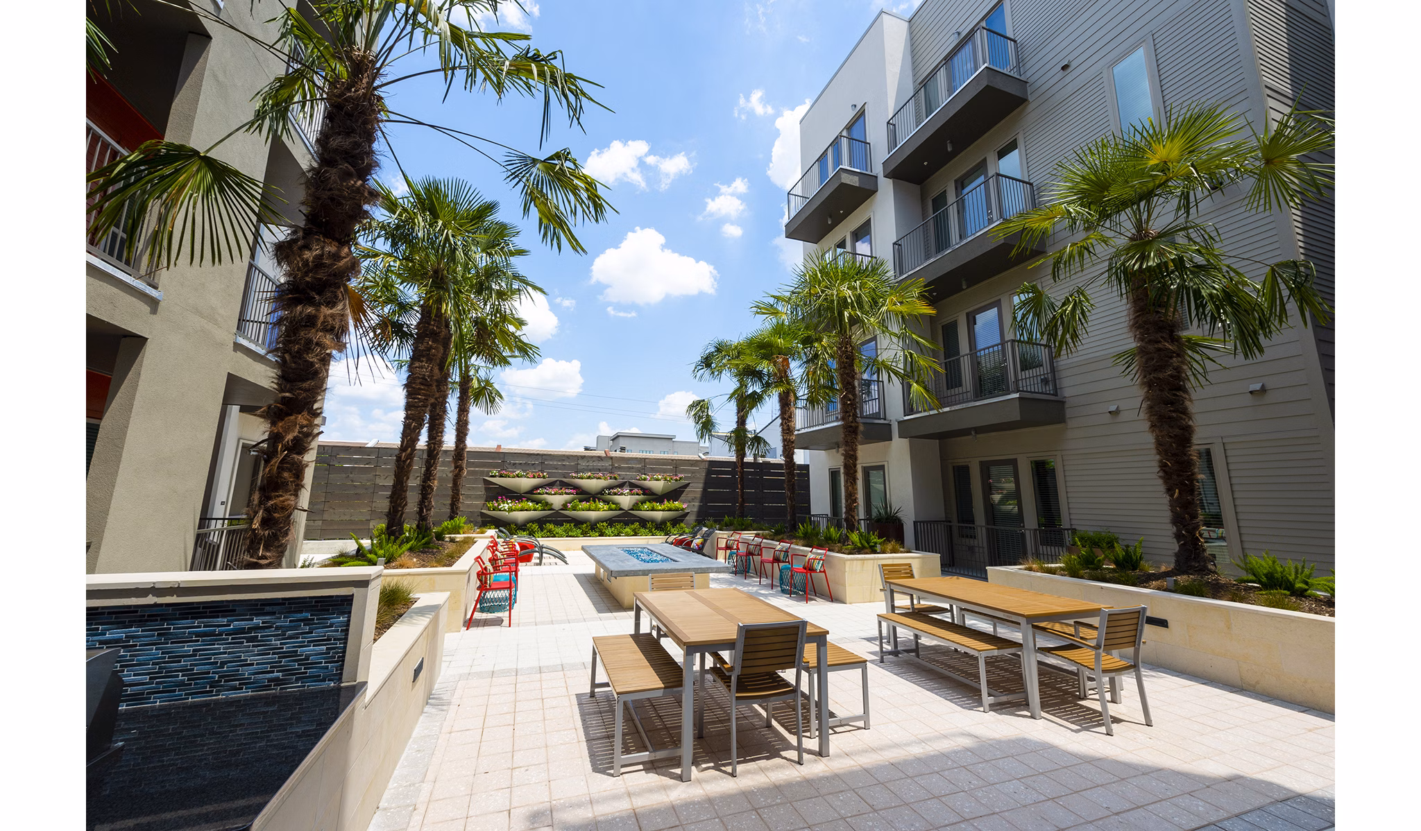 Outdoor lounge area with fire pit at Encore Montrose Apartments, ideal for relaxing and socializing