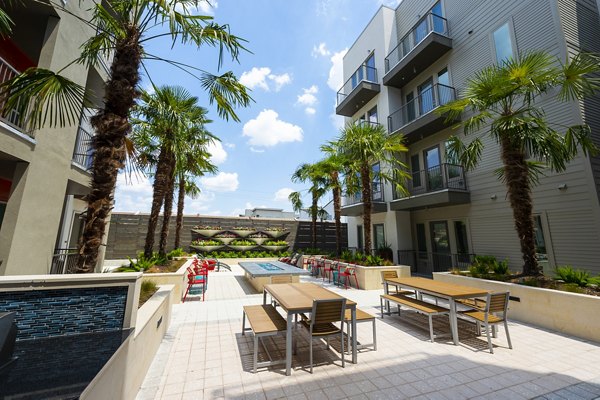 Outdoor lounge area with fire pit at Encore Montrose Apartments, ideal for relaxing and socializing