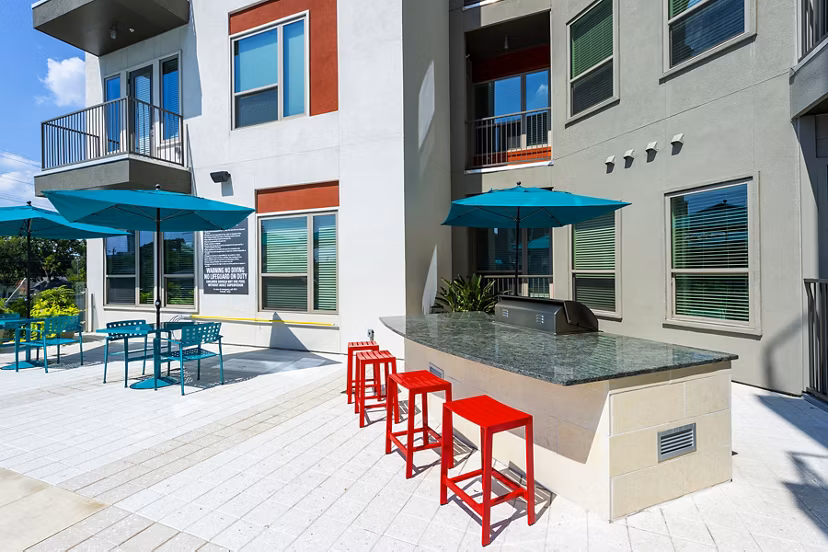 Outdoor grill area with sleek stainless-steel grills at Encore Montrose Apartments, perfect for hosting gatherings and enjoying dining al fresco
