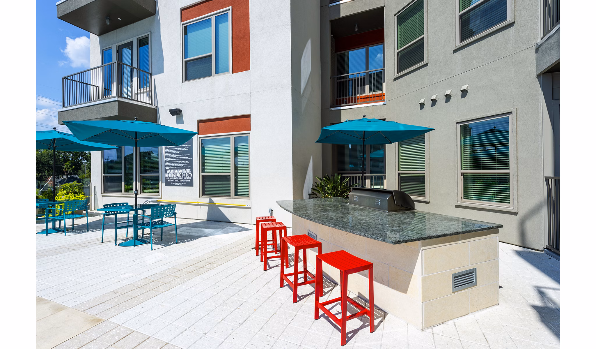 Outdoor grill area with sleek stainless-steel grills at Encore Montrose Apartments, perfect for hosting gatherings and enjoying dining al fresco