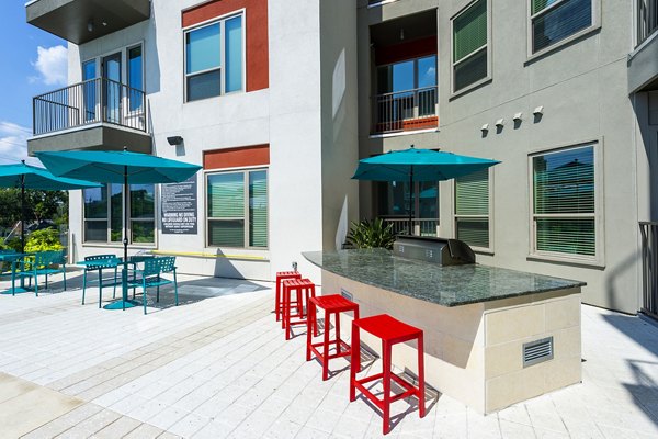 Outdoor grill area with sleek stainless-steel grills at Encore Montrose Apartments, perfect for hosting gatherings and enjoying dining al fresco