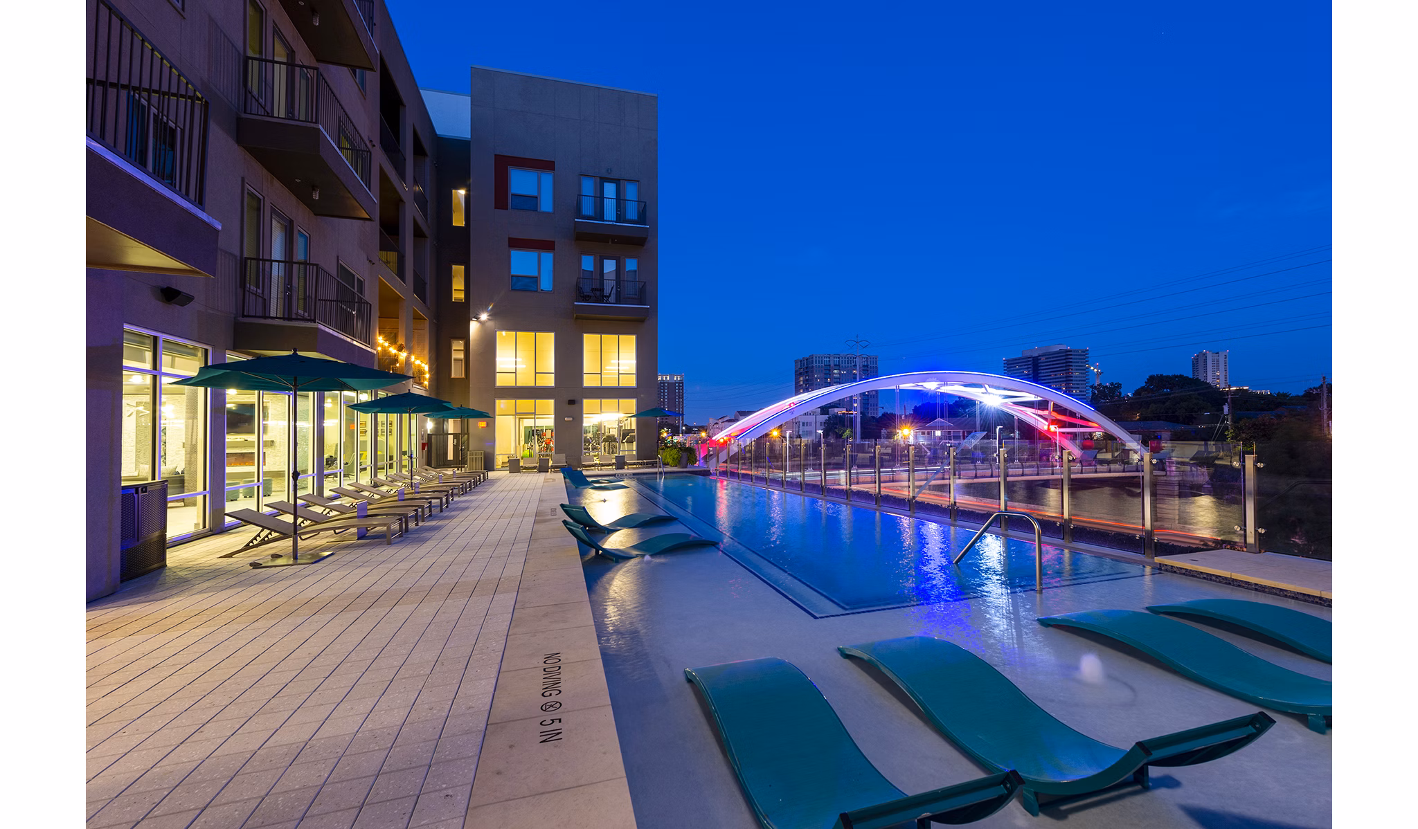 Resort-style pool with lounge chairs at Encore Montrose Apartments, offering luxury living in a vibrant community