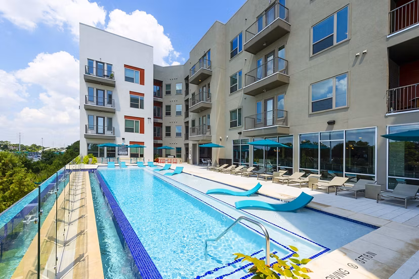 Luxurious pool with seating area at Encore Montrose Apartments offering relaxation and leisure amenities in a prime location