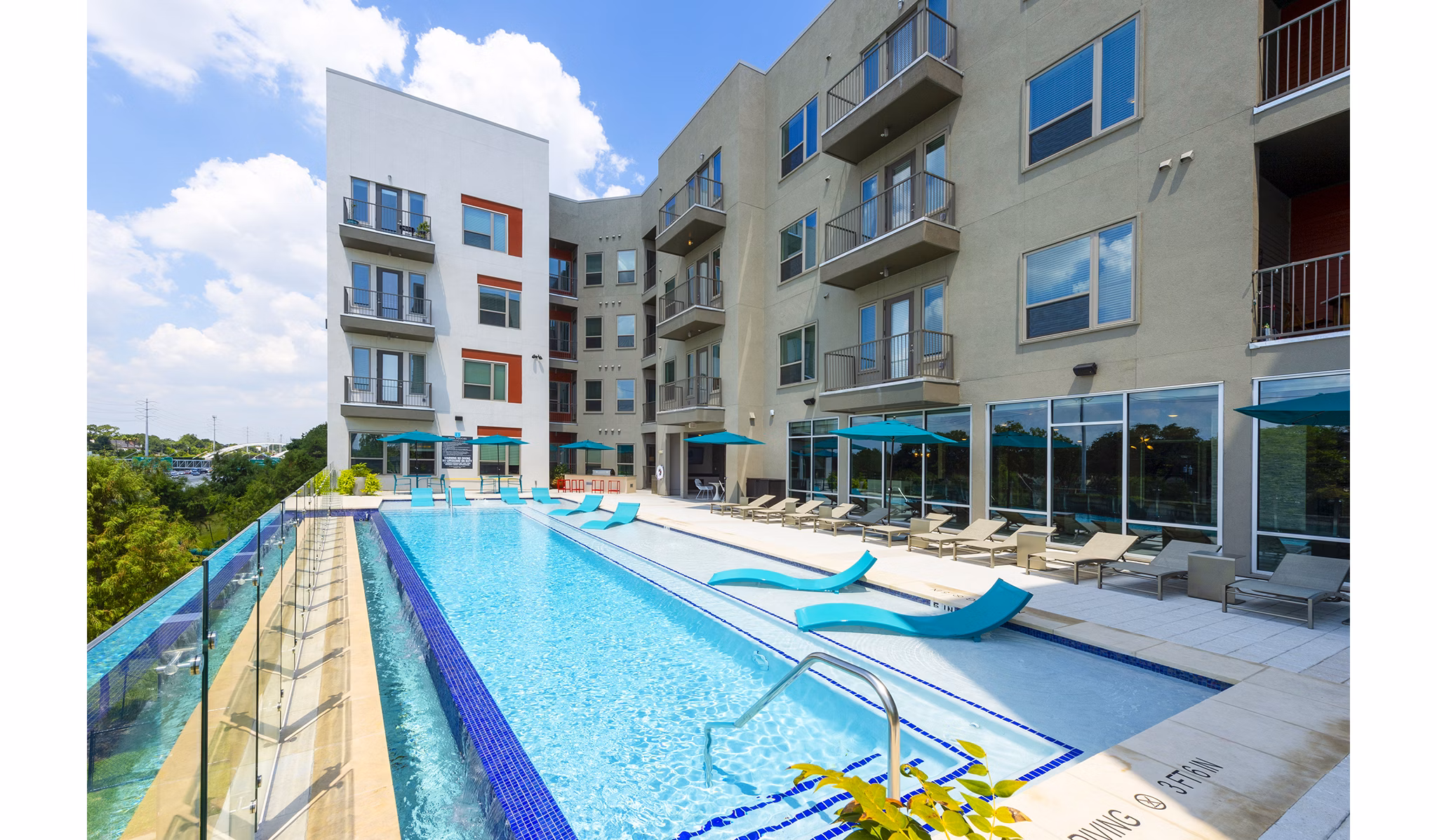 Luxurious pool with seating area at Encore Montrose Apartments offering relaxation and leisure amenities in a prime location
