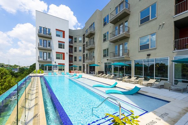 Luxurious pool with seating area at Encore Montrose Apartments offering relaxation and leisure amenities in a prime location
