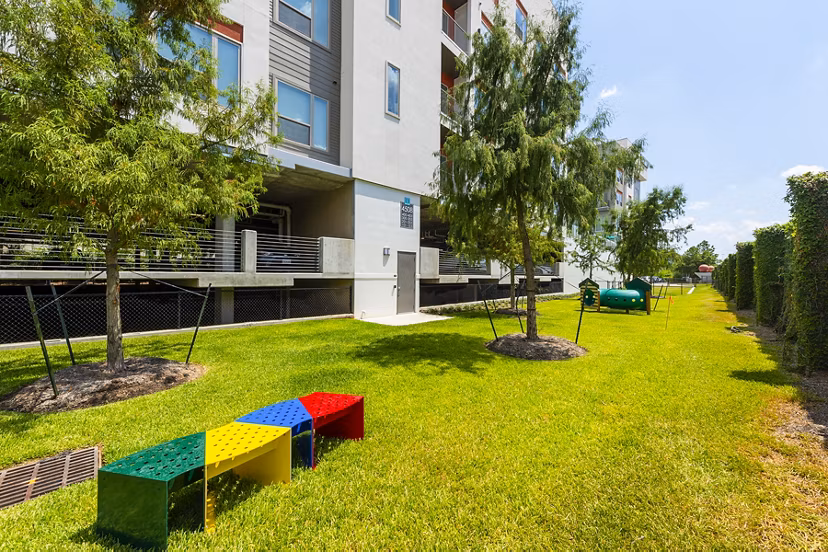 Modern dog park with agility equipment at Encore Montrose Apartments, perfect for pet-friendly living