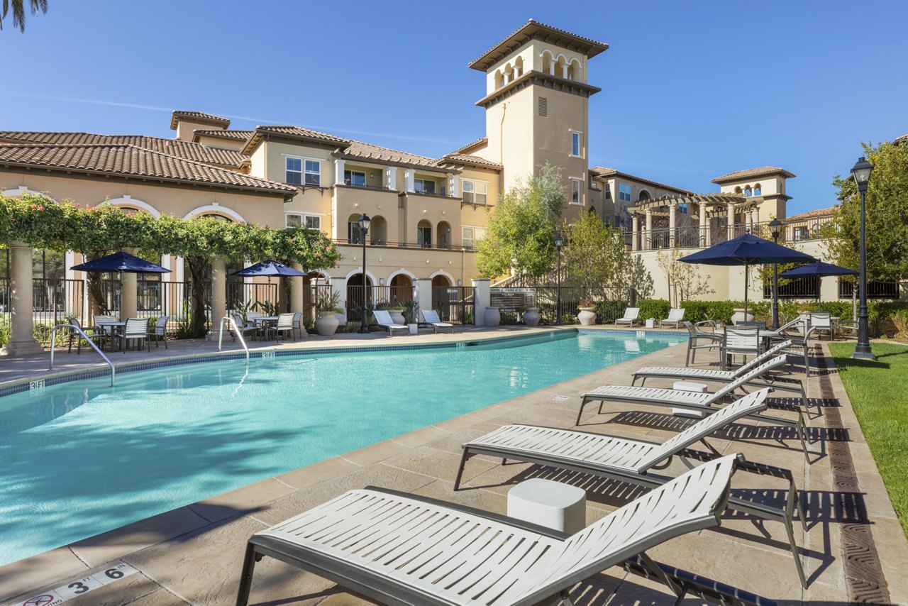 Modern poolside lounge with cabanas at Aventino Apartments offering luxury relaxation