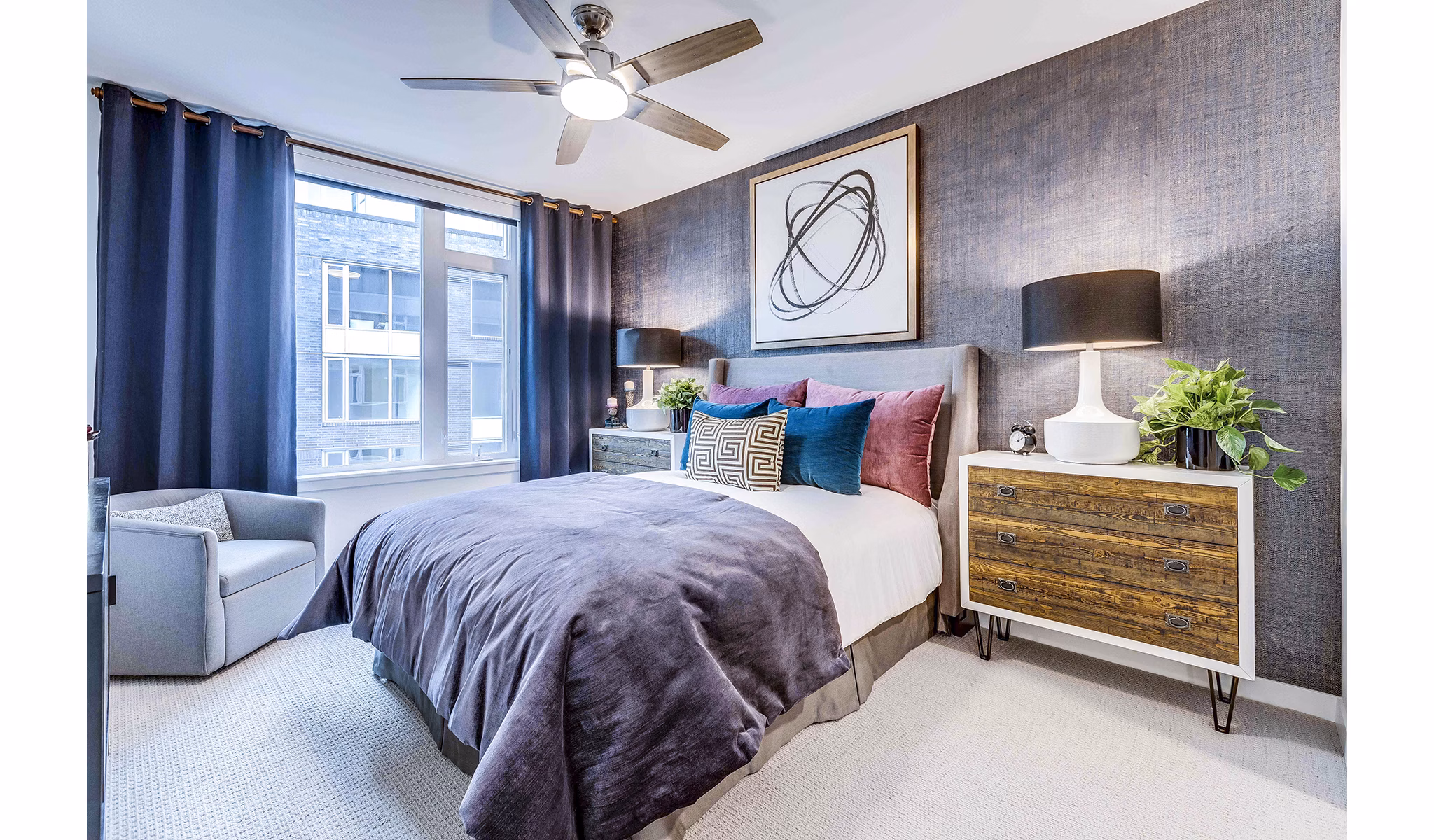 Cozy bedroom with sleek designs at Marlowe Apartments, featuring modern decor and ample natural light