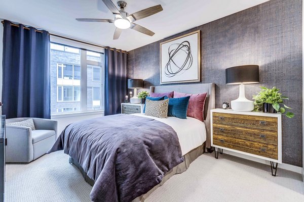 Cozy bedroom with sleek designs at Marlowe Apartments, featuring modern decor and ample natural light