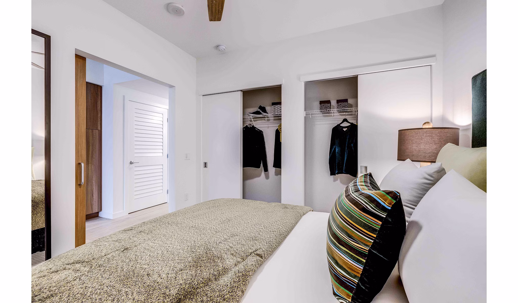 Cozy bedroom with modern furniture and natural light at Marlowe Apartments, a luxury living option by Greystar