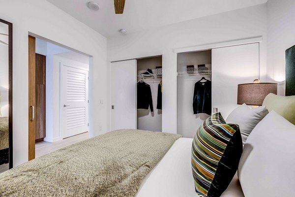 Cozy bedroom with modern furniture and natural light at Marlowe Apartments, a luxury living option by Greystar