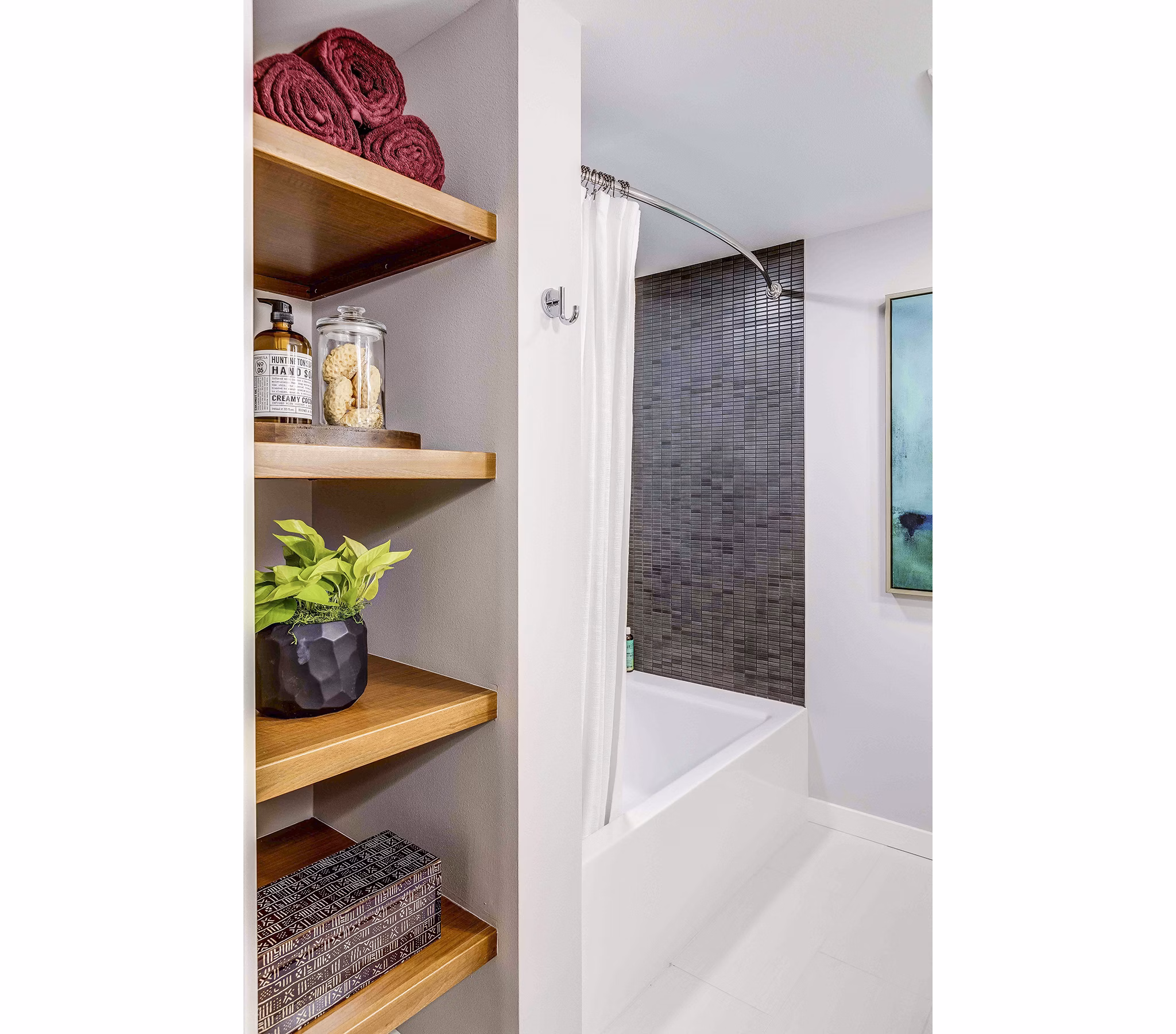 Bathroom featuring sleek fixtures and tile design at Marlowe Apartments