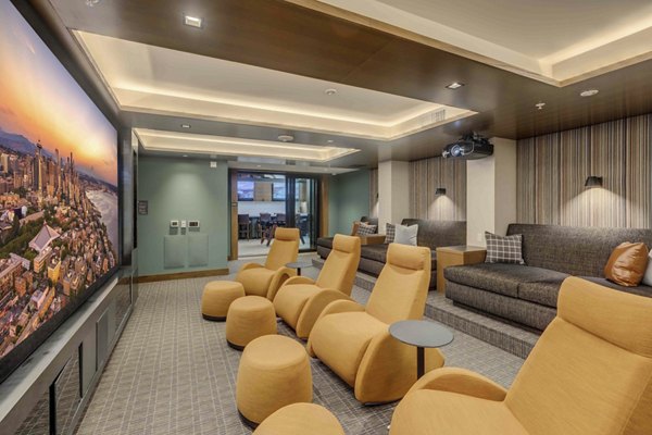 Marlowe Apartments: Modern theater with plush seating and large screen for residents to enjoy movies and events