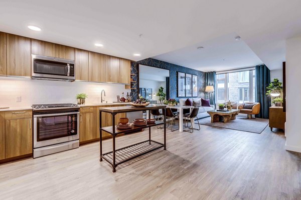 Modern kitchen with stainless steel appliances and quartz countertops at Marlowe Apartments