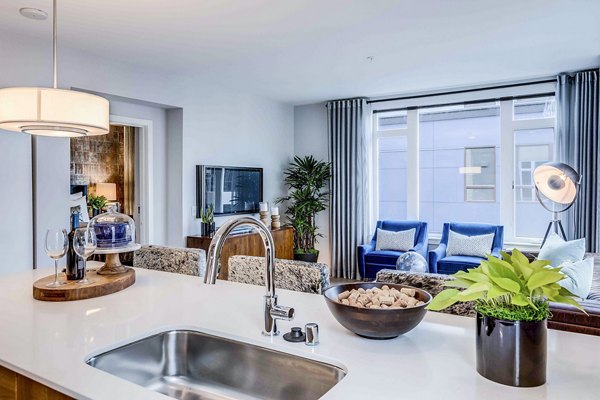 Modern kitchen with stainless steel appliances and granite countertops in Marlowe Apartments luxury residence