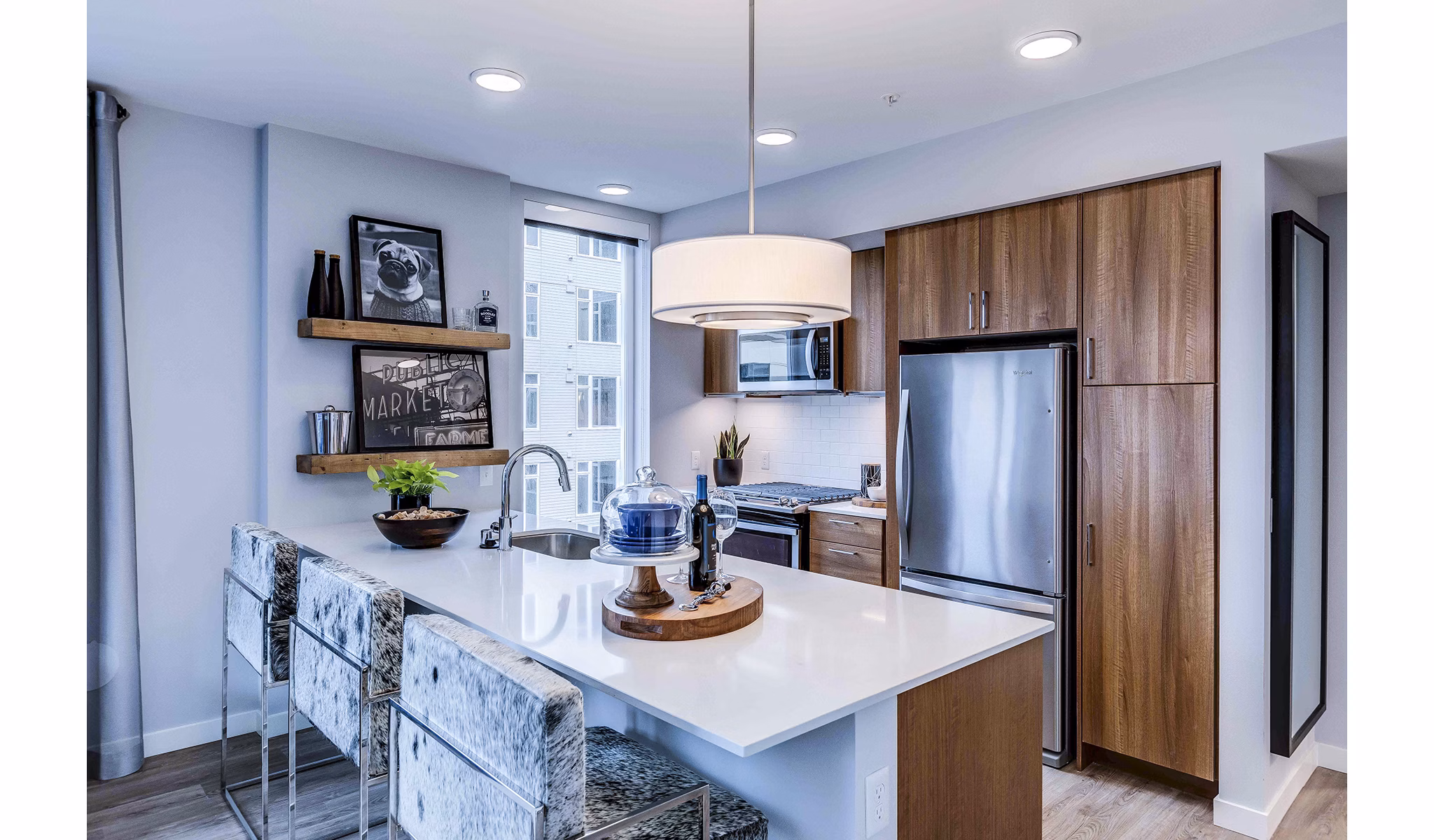 Modern kitchen with stainless steel appliances and granite countertops at Marlowe Apartments