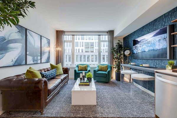 Spacious living room featuring elegant furnishings and natural light at Marlowe Apartments