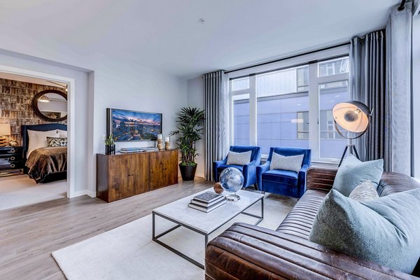 Modern living room with chic furniture and large windows at Marlowe Apartments
