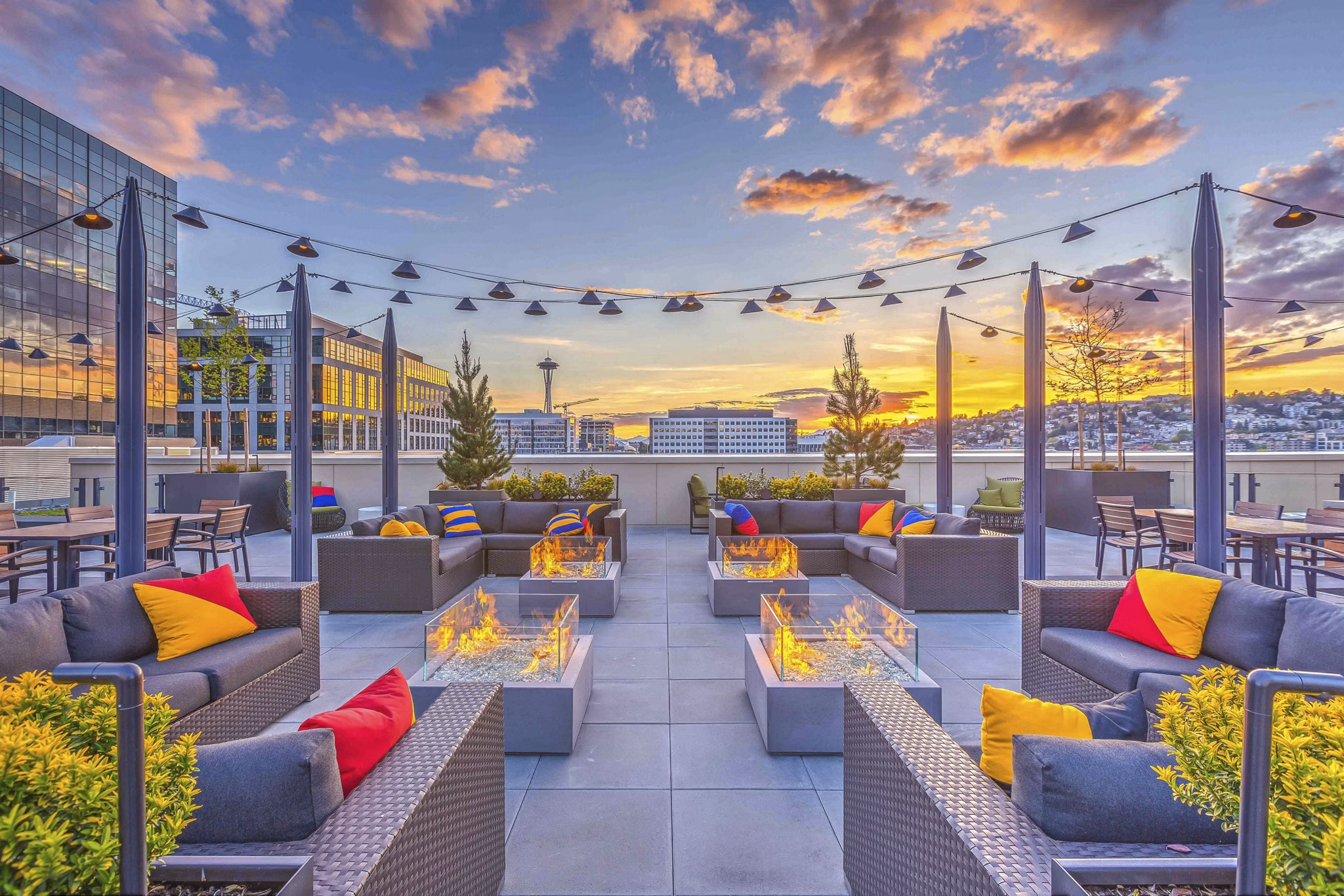 Modern rooftop deck with seating areas at Marlowe Apartments featuring expansive city views