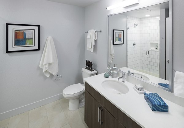 Modern bathroom with sleek fixtures at Alexan LoHi Apartments, featuring a luxurious design for comfortable living