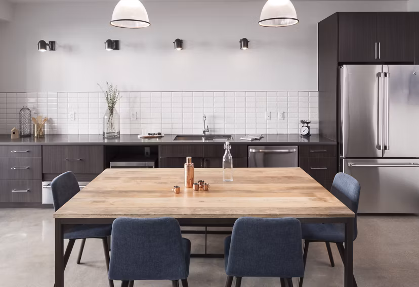 Modern clubhouse featuring cozy seating and a fireplace at Alexan LoHi Apartments, luxury community in Denver
