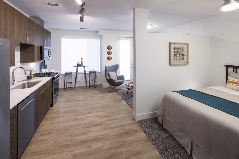 Modern kitchen with stainless steel appliances in Alexan LoHi Apartments